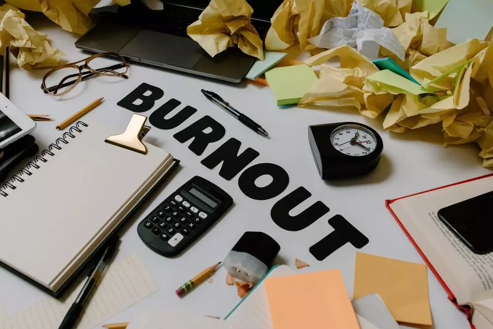 uma mesa de trabalho com post its amassados onde se lê Burnout.